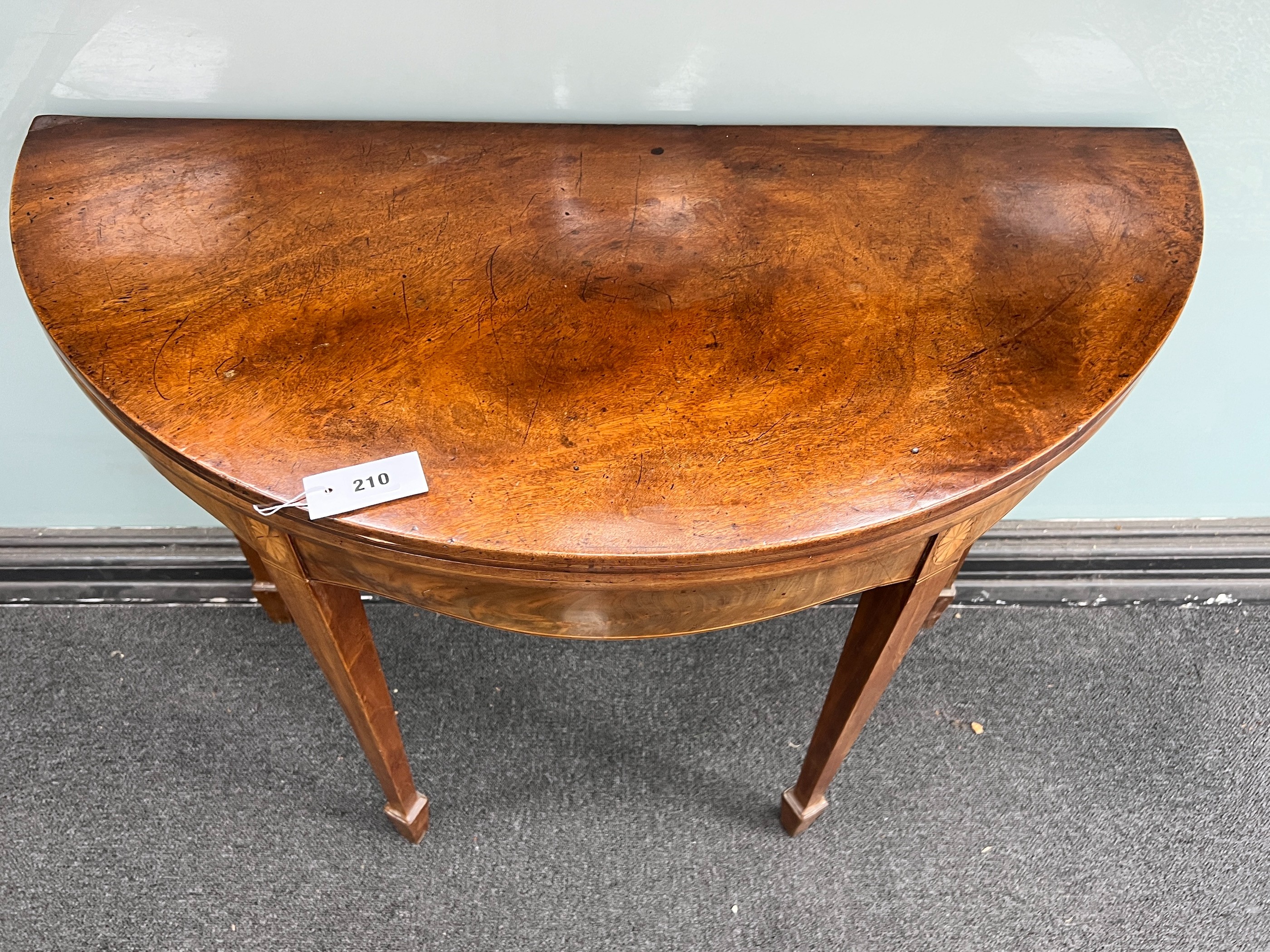 A George III inlaid mahogany demi-lune folding tea table, width 96cm, depth 45cm, height 74cm